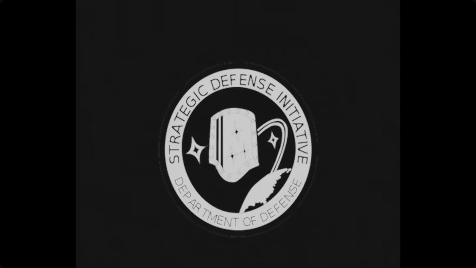 The Strategic Defense Initiative emblem captures the Cold War paranoia that drove Buran's development — Soviet leaders feared orbital weapons platforms and needed a response.